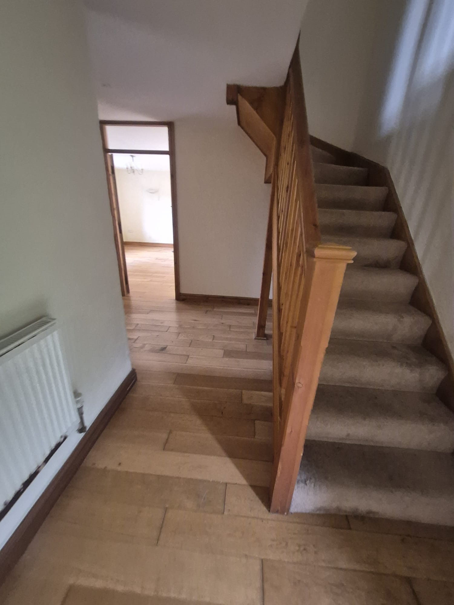 Hallway after decorating — white painted staircase and woodwork