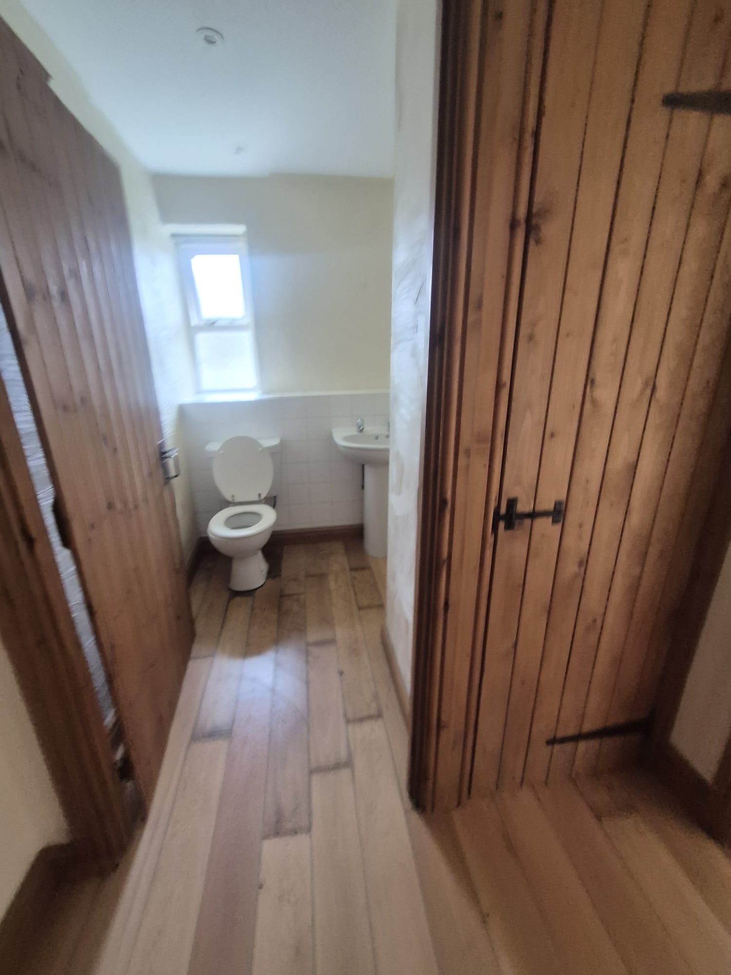 Bedroom with pine door and frame, carpeted floor